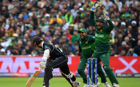 Pakistan's captain Sarfaraz Ahmed (R) celebrates after taking a catch for the dismissal of Black Caps captain Kane Williamson (L) during the 2019 Cricket World Cup group stage match between New Zealand and Pakistan at Edgbaston in Birmingham.