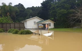 Northland flooding with a New Zealand First billboard.
