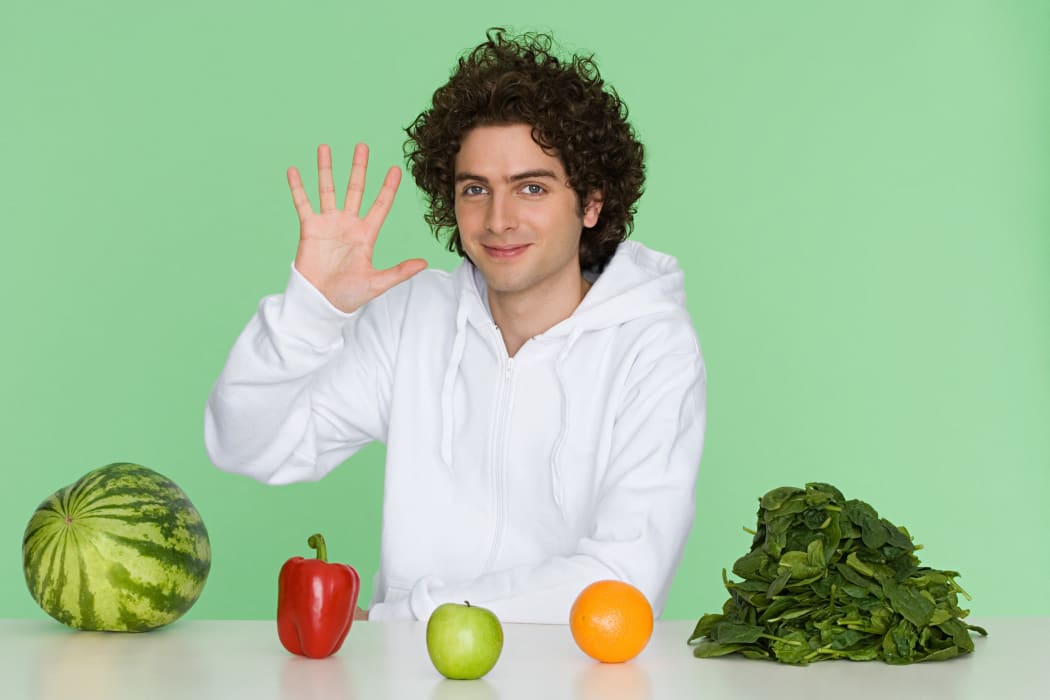 Young man with fruit and vegetables (Photo by NEIL GUEGAN / Image Source / Image Source via AFP)