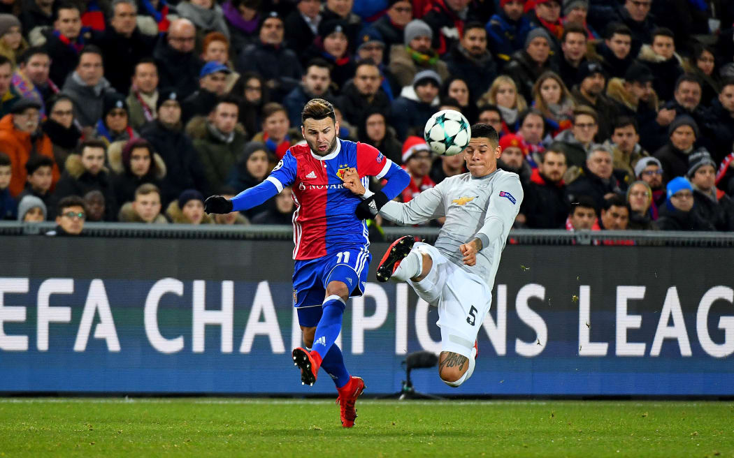 Renato Steffen of FC Basel challenges Marcus Rojo of Manchester United for the ball