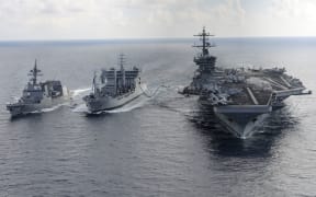 Aircraft carrier USS Theodore Roosevelt (CVN 71) and Japanese Maritime Self-defense Force Akizuki-class destroyer JS Fuyuzuki (DD-118)(L) transit alongside the Indian Deepak-class fleet tanker INS Shakti (A 57)(C) during a replenishment-at-sea exercise as a part of Exercise Malabar 2015.