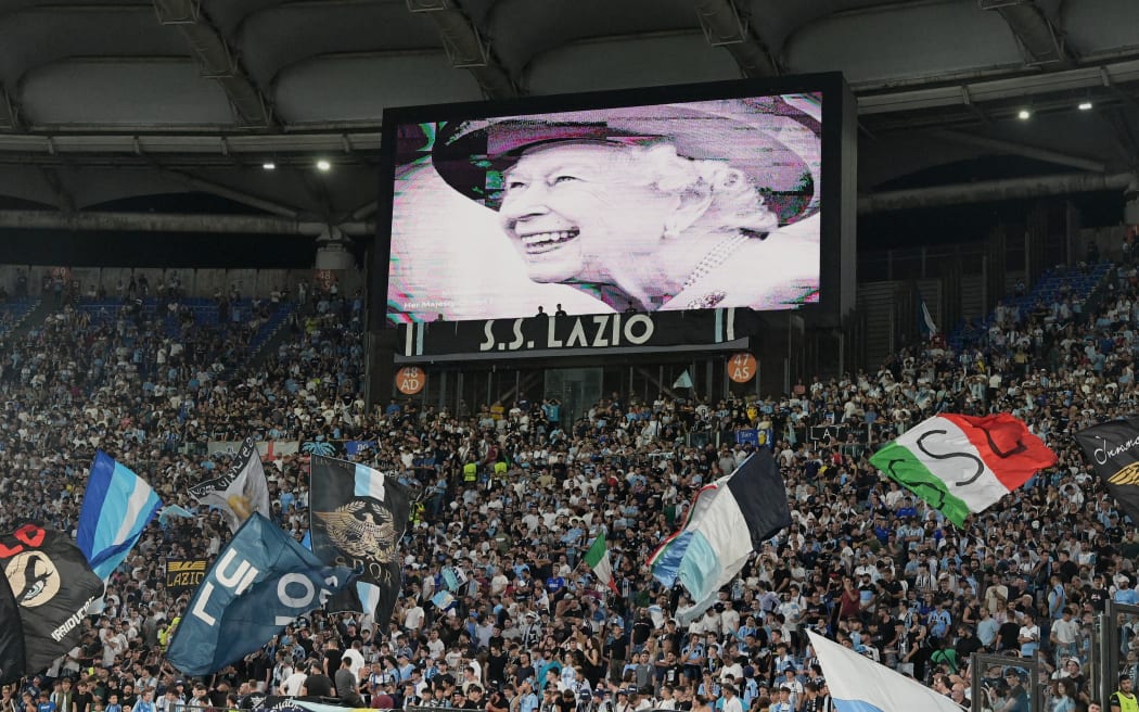 A portrait of Britain's  Queen Elizabeth II is displayed on a giant screen following the announcement of her death, prior to the start of the UEFA Europa League Group F first leg football match between SS Lazio and Feyenoord Rotterdam at the Olympic stadium in Rome on September 9, 2022.