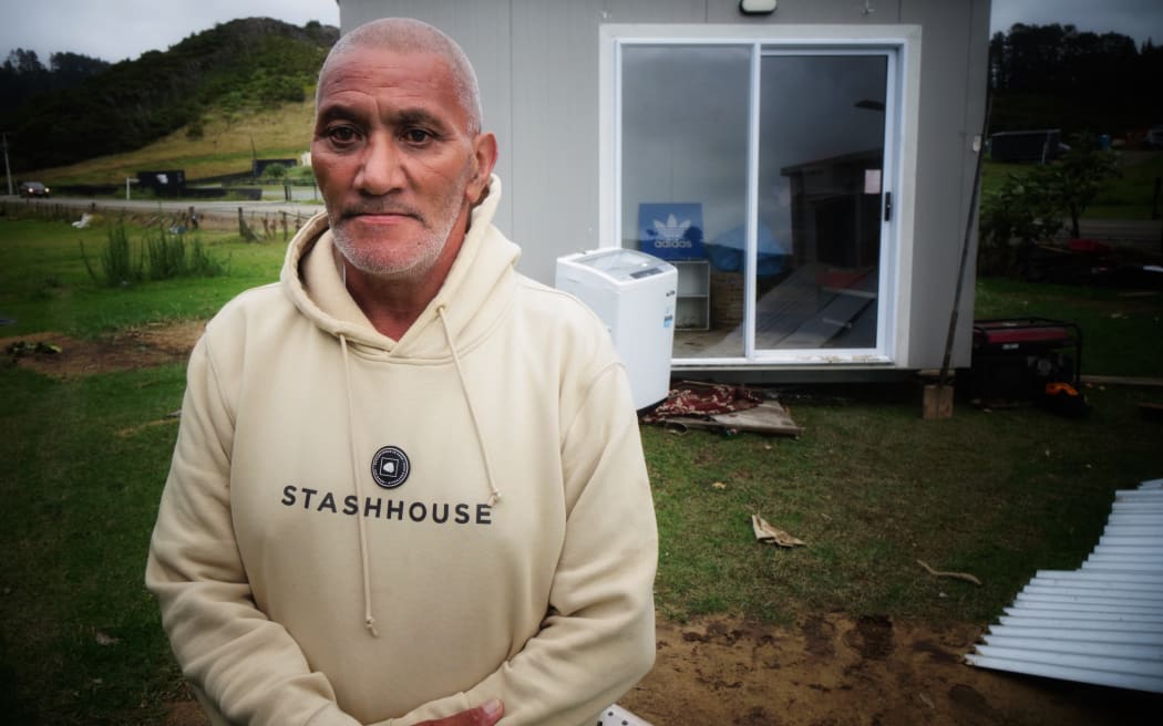 Pattinson Wetere outside one of the cabins shunted by the raging water.