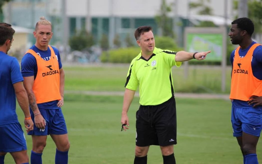 Guam football coach Gary White issues instructions during training.