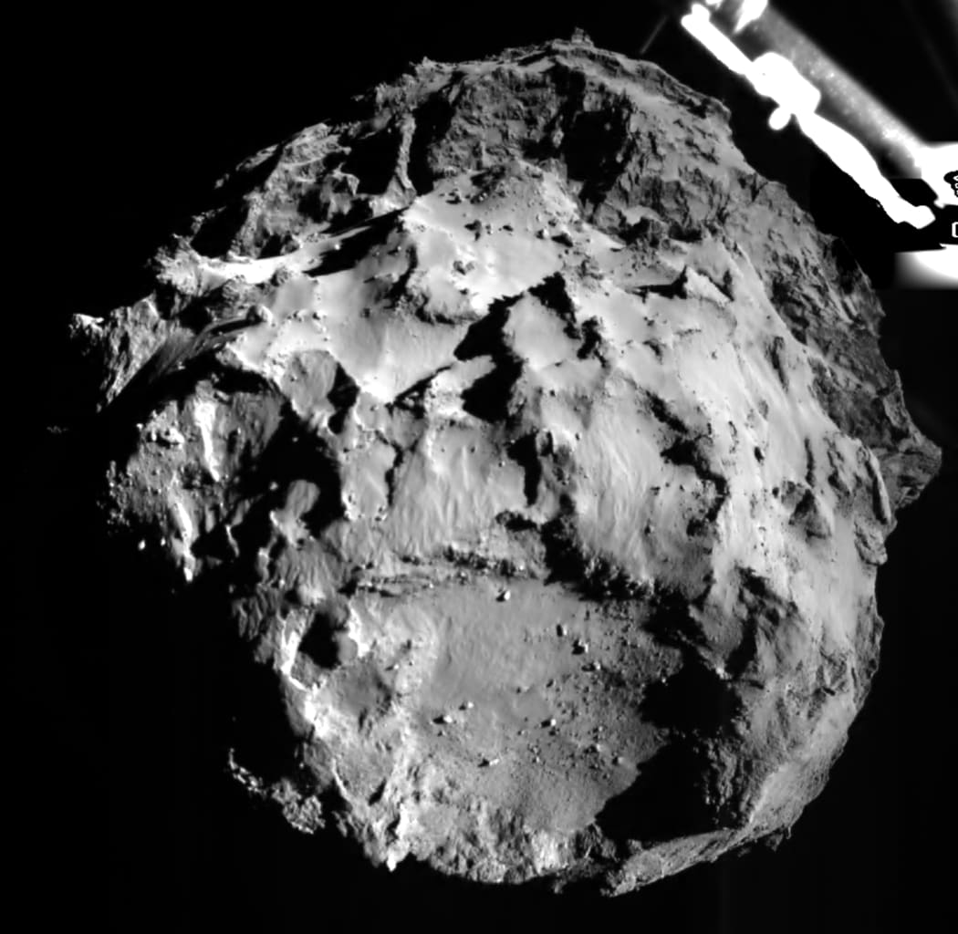 The comet shown from a camera on Philae about 3km from the surface. A segment of the probe's landing gear is visible in the upper right hand corner.