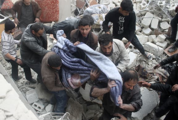 A victim is pulled from the rubble of a building in the northern Syrian city of Aleppo.