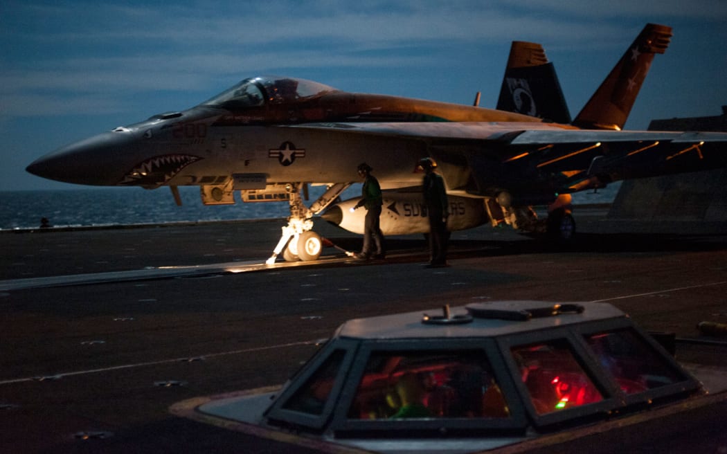 A US F/A-18E Super Hornet - shown on the flight deck of an aircraft carrier supporting strikes in Iraq and Syria.