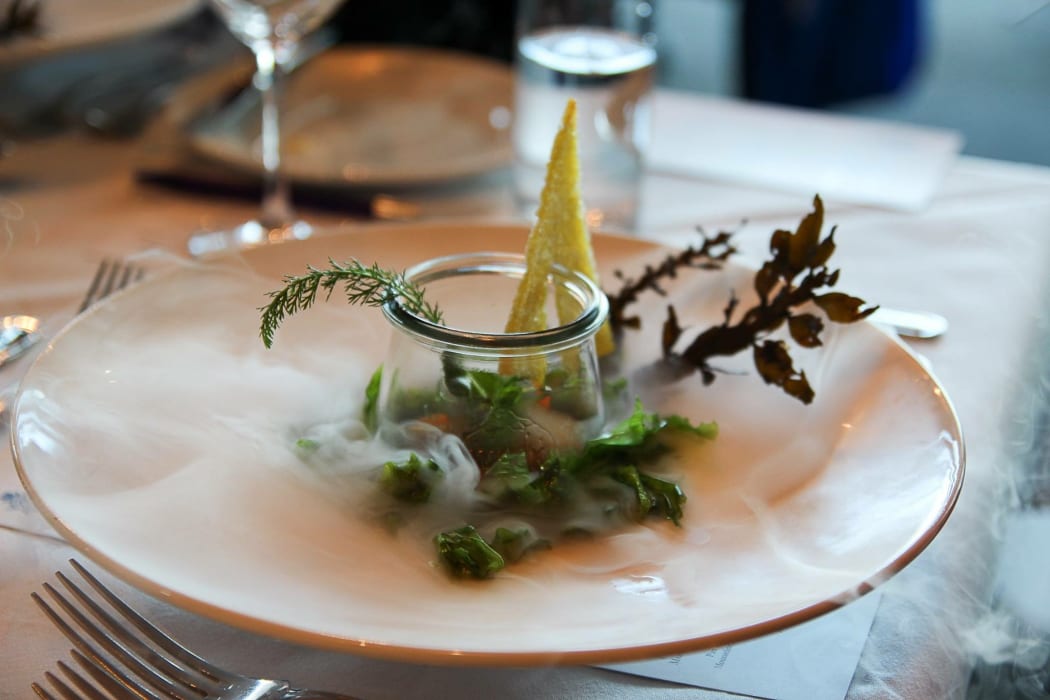 Scallops and poached eggs with syphon holandaise on a bed of sea lettuce with dry ice