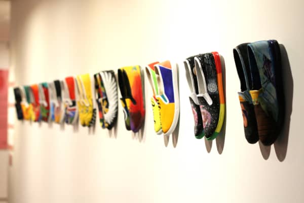 Artists in prisons transformed plain canvas shoes for the Worn exhibition.