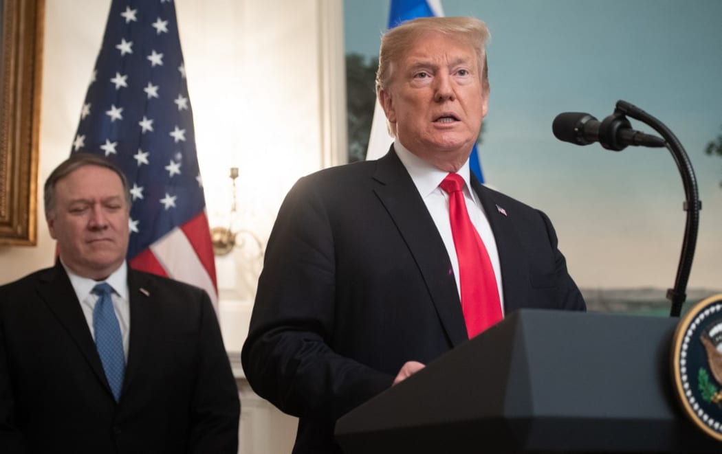 US President Donald Trump speaks alongside US Secretary of State Mike Pompeo (L)