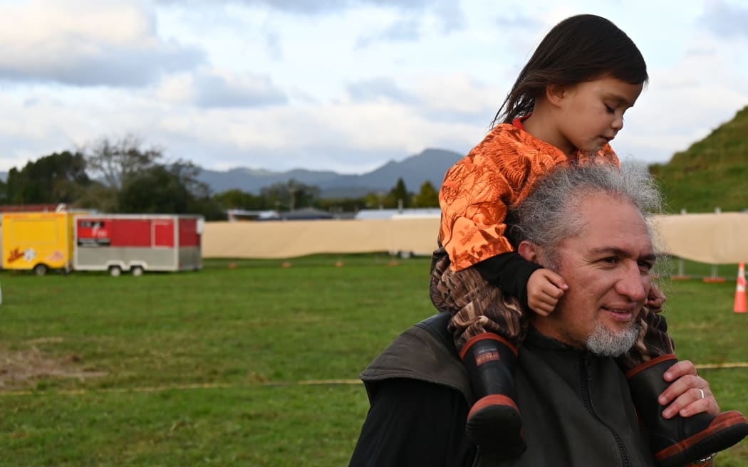 Poia Rewi with his mokopuna Poia Paku on his shoulders.
