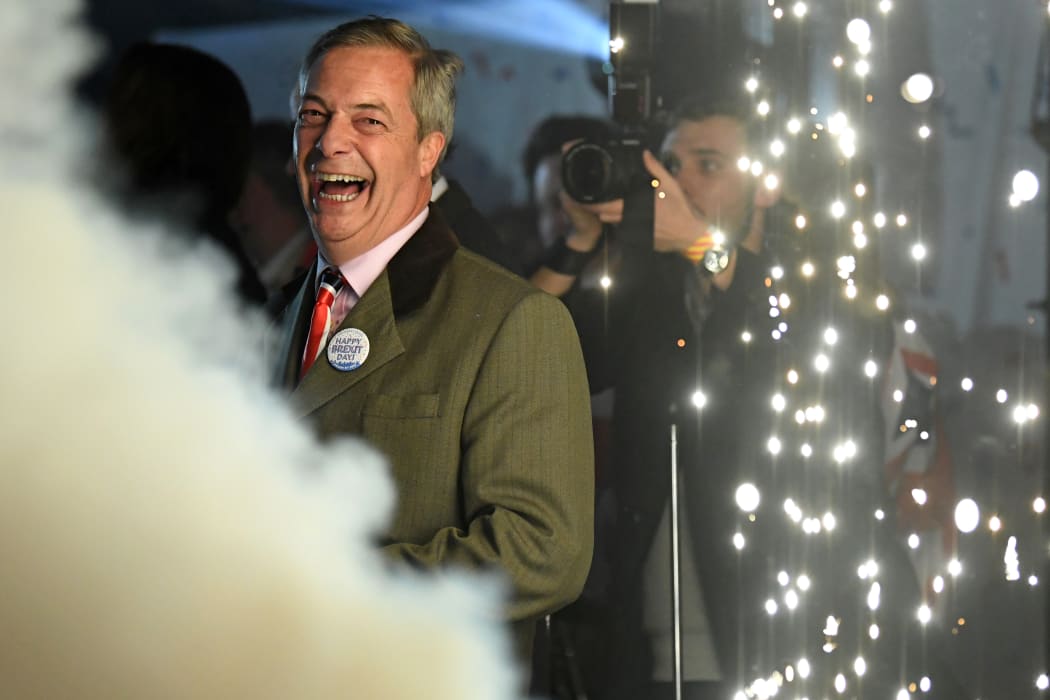 Brexit Party leader Nigel Farage smiles on stage in Parliament Square.