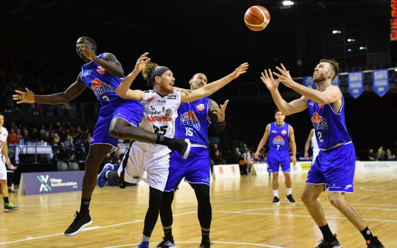 Hawks El Singler (Center L) has a shot intercepted by Saints Sunday Dench (L) and Leon Henry (Centre R) and drops into the hands of team mate Nick Kay during the NBL basketball match between the Wellington Saints and Hawkes Bay Hawks at the TSB Arena on Friday the 12th April 2019.