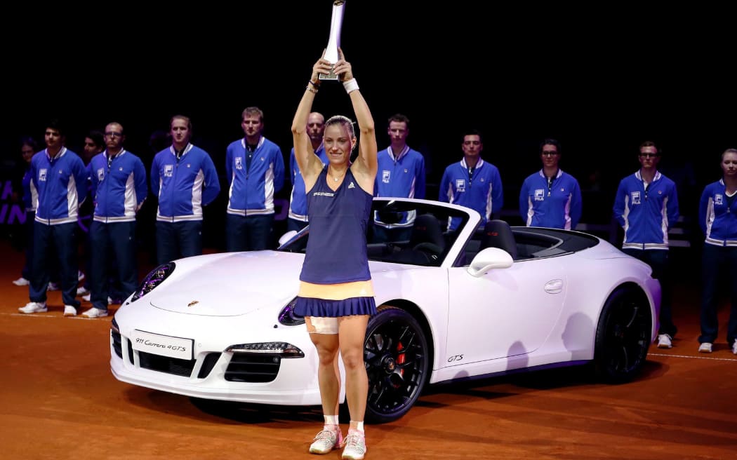 Angelique Kerber hoists the 2015 Stuttgart trophy.