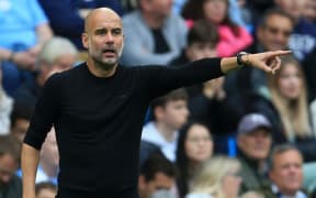 Manchester City manager Pep Guardiola points the way