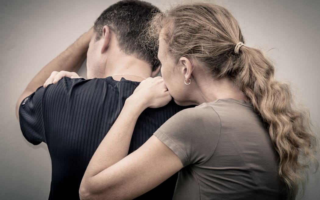 Sad woman hugging her husband