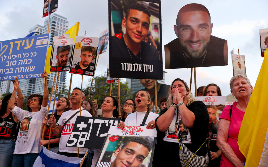 Israelis watch on a screen the release of Edan Alexander, an Israeli-US captive in the Gaza Strip since October 2023, at Hostages Square in Tel Aviv on 12 May, 2025.