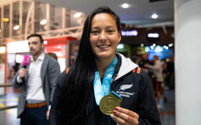 Tyla Nathan-Wong arrives back home with her Black Ferns team members in New Zealand after defending their sevens world cup title in San Francisco.
