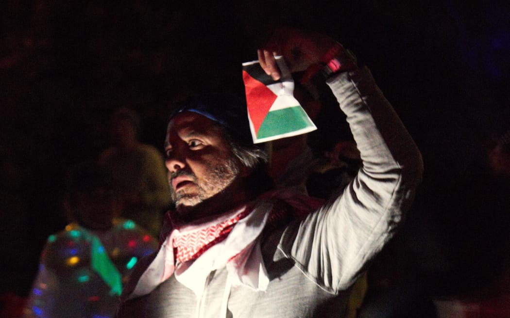 A protester holds up a Palestinian flag as Ziggy Marley performs on the second day of WOMAD in Taranaki, on 17 March, 2024.
