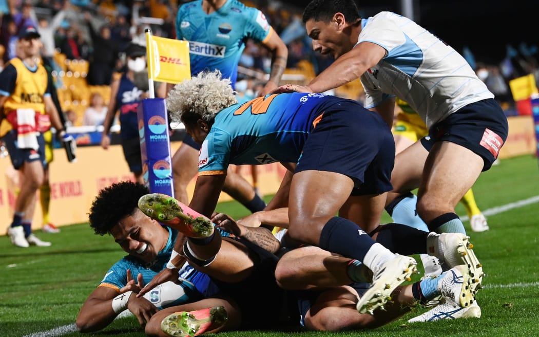 Moana Pasifika player Tima Fainga’anuku is tackled by Waratahs player Dylan Pietsch.