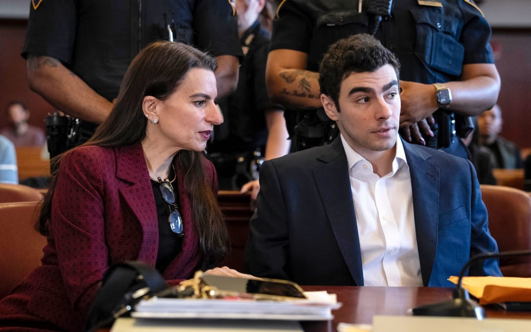 Luigi Mangione appears with his attorney Karen Friedman Agnifilo for a hearing in the killing of UnitedHealthcare CEO Brian Thompson in Manhattan Criminal Court on December 12, 2025.