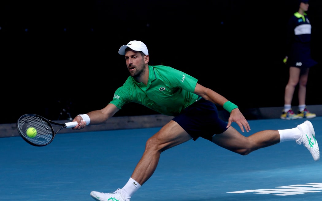 Serbia's Novak Djokovic hits a return to Italy's Lorenzo Musetti during their men's singles quarter-final match on day eleven of the Australian Open tennis tournament in Melbourne on January 28, 2026. (Photo by IZHAR KHAN / AFP) / -- IMAGE RESTRICTED TO EDITORIAL USE - STRICTLY NO COMMERCIAL USE --