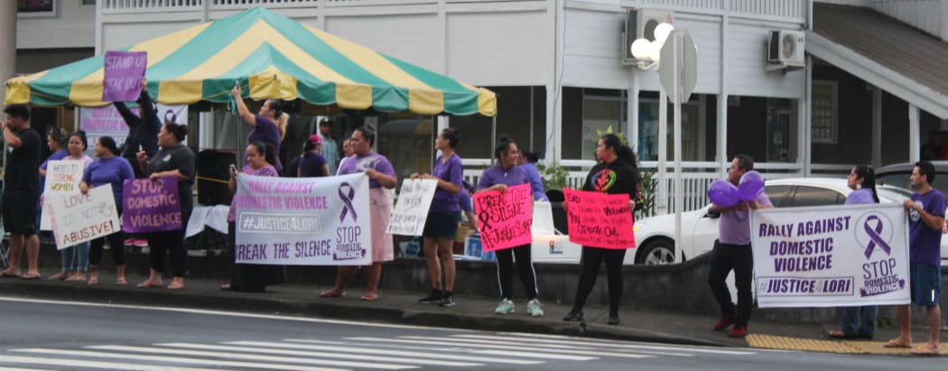 Supporters line the road in downtown Fagatogo during a rally against domestic violence