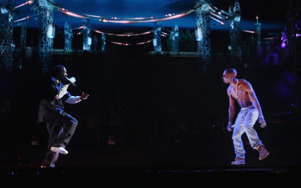 Rapper Snoop Dogg (left) and a hologram of deceased rapper Tupac Shakur perform onstage during Coachella 2012 in Indio, California.