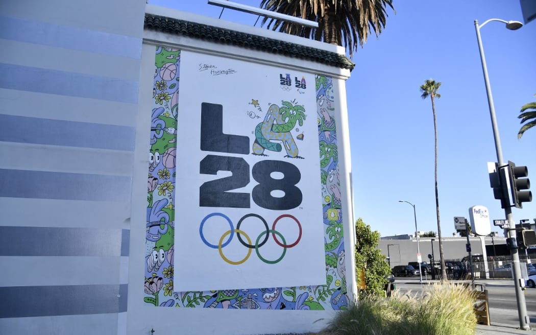 LOS ANGELES, CALIFORNIA - SEPTEMBER 01: The LA28 Olympic mural by Artist Steven Harrington is displayed on the corner of Stanley street and Sunset Boulevard on September 01, 2020 in Los Angeles, California. The mural is one of three LA28 logo murals revealed throughout Los Angeles to celebrate the upcoming Games of the XXXIV Olympiad. The 2028 Summer Olympics are scheduled to take place from July 21, 2028 to August 6, 2028.   Frazer Harrison/Getty Images/AFP (Photo by Frazer Harrison / GETTY IMAGES NORTH AMERICA / Getty Images via AFP)