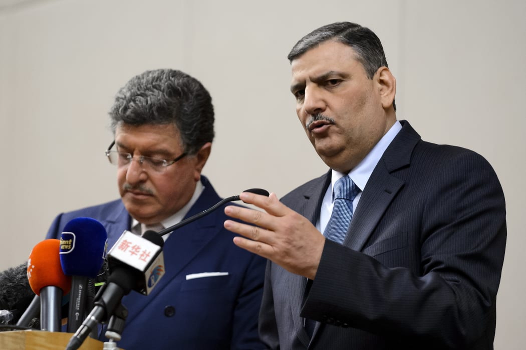Syrian opposition chief Riad Hijab (R) gestures next to High Negotiations Committee (HNC) spokesman Salem al-Meslet during a press conference after Syrian peace talks on 3 February 2016 in Geneva.