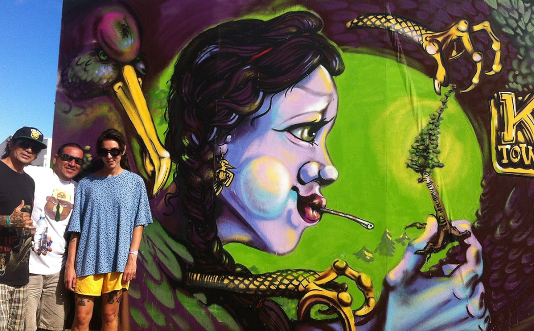 Erin Forsyth stands by her work at the Street legal Festival in Kawerau this year  Image courtesy if the artist.