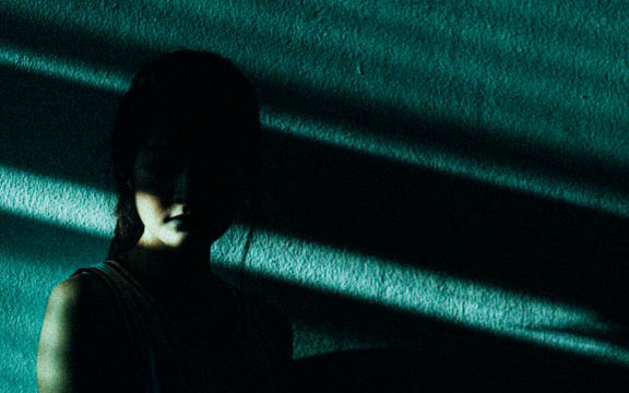 Photo of dark shadows cast over person's face