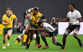 Fiji's scrum-half Frank Lomani tackles Australia's centre Samu Kerevi during the match between Australia and Fiji.