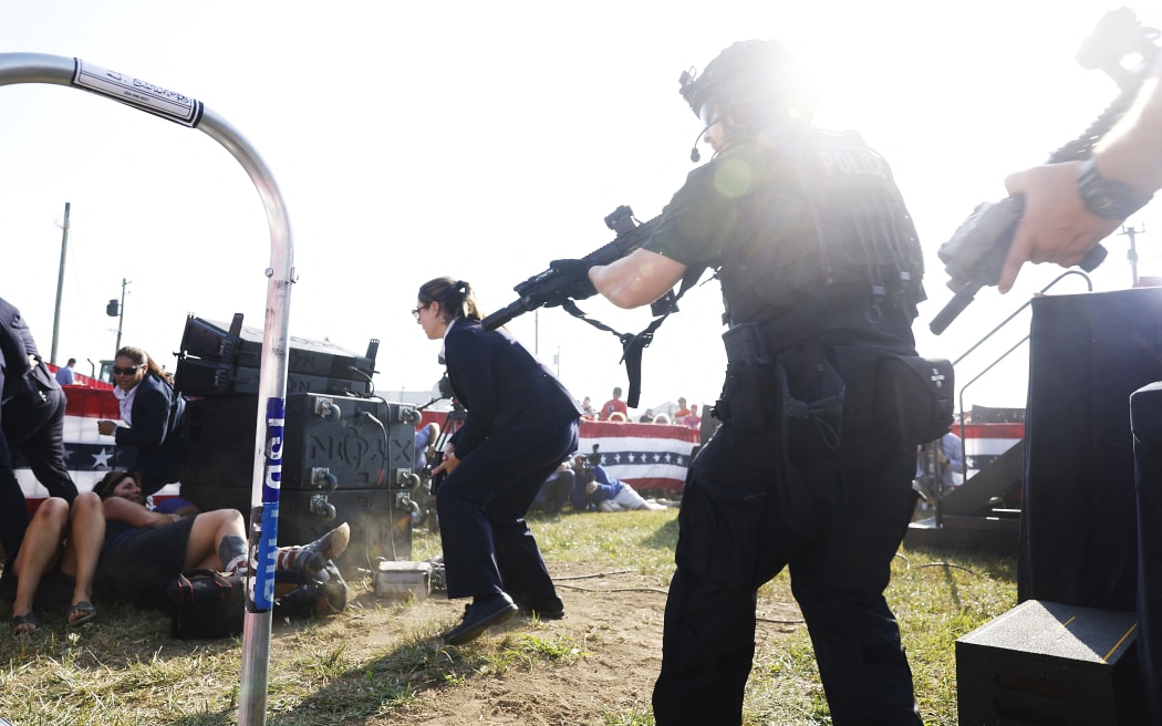 Law enforcement react after shots were fire at a rally for US republican presidential candidate former President Donald Trump, on 13 July, 2024 in Butler, Pennsylvania.