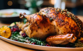 Roasted chicken with pomegranate and rosemary on wooden table