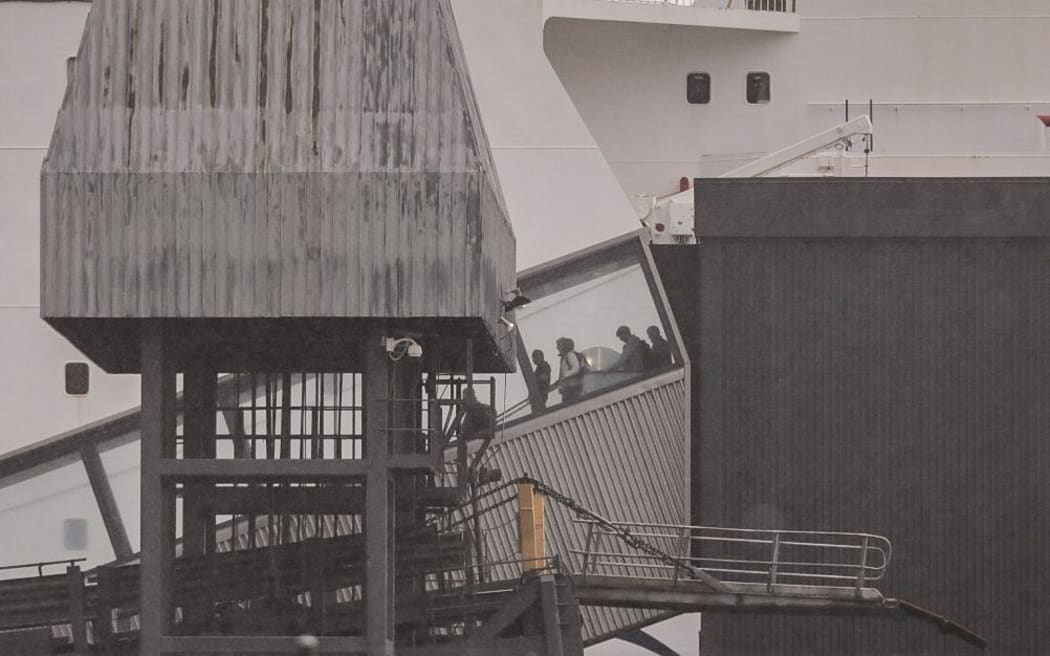 Passengers disembarking the Interislander ferry that returned to Wellington port due to a security threat.