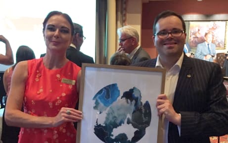 National List MP for Wellington Central Paul Foster-bell shows off a piece of artwork he won in the auction with the Chief Executive of NORD Letitia O'Dwyer (left).