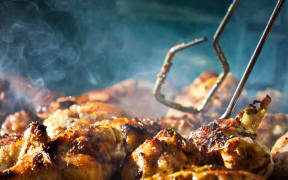 Chicken being cooked on a barbecue.