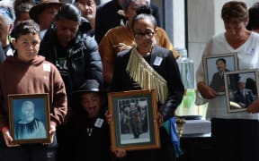 Caption Ngāti Hāua iwi members carry their loved ones to Parliament for the final reading of their Treaty settlement.