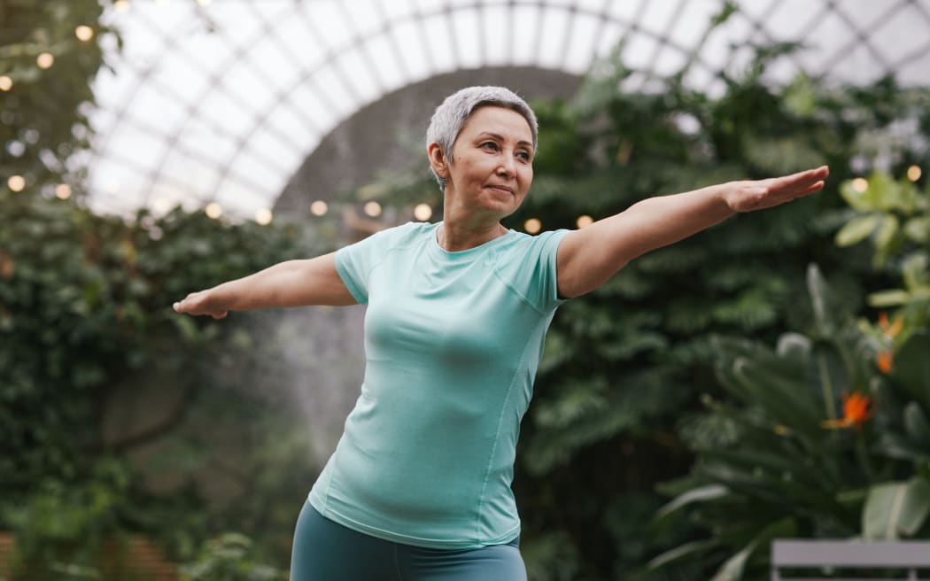 older woman doing yoga