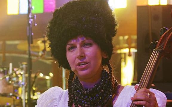 Nina Garenetska and her cello painted with traditional Ukrainian folk motifs