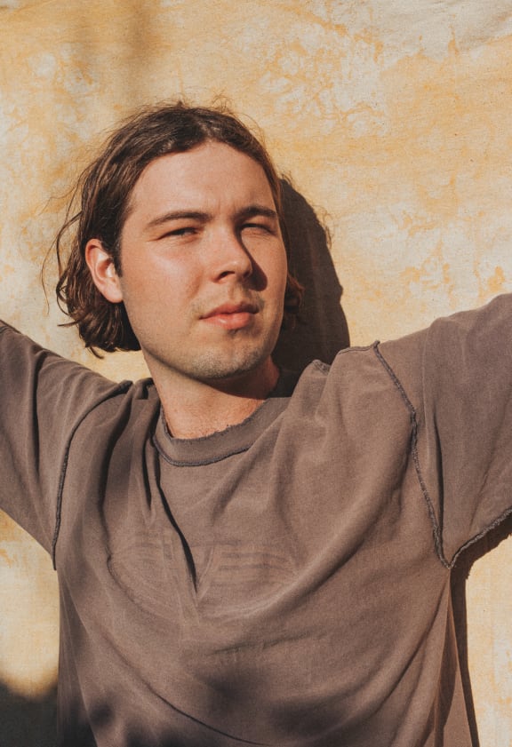 Musician Will Gillivray, aka Goodwill, standing in the sunshine