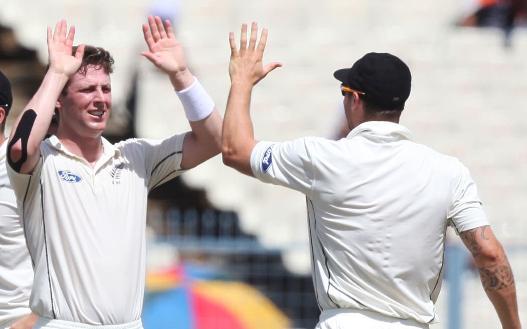 Matt Henry celebrates taking a wicket.