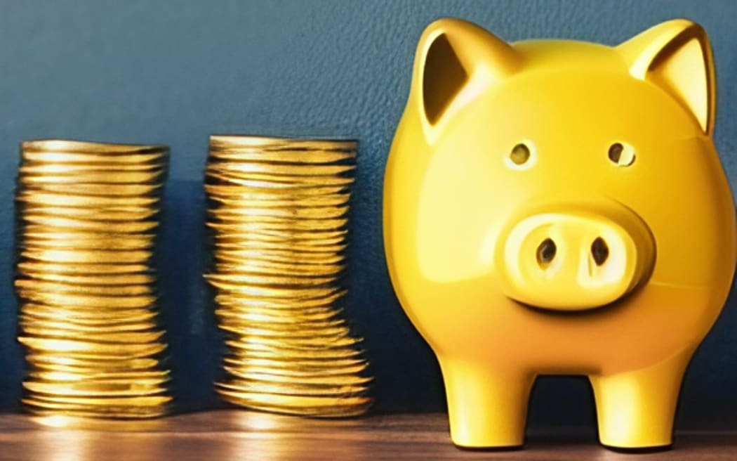 A line of coins are stacked up against a wall with a golden piggy bank at one end.