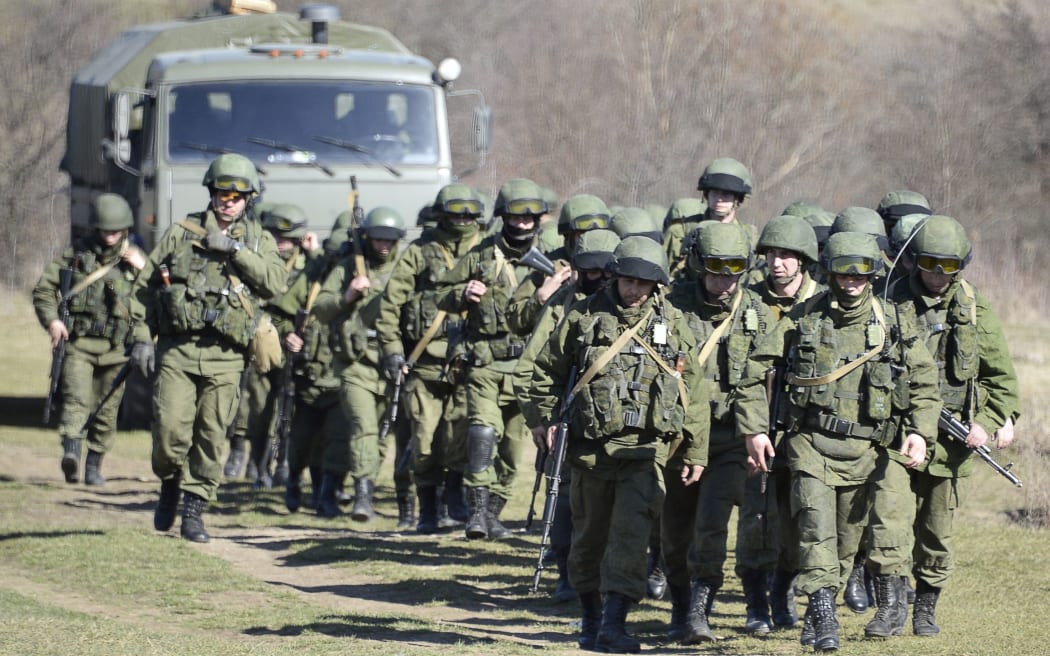 Armed men block access to a Ukrainian border guard base outside Perevalne.