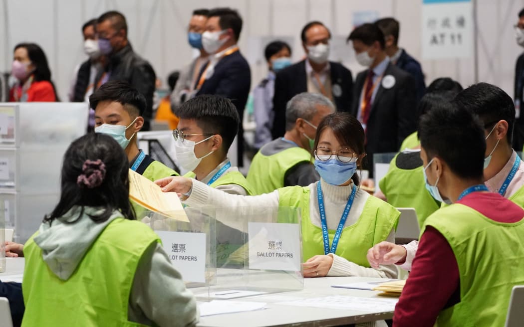 (211220) -- HONG KONG, Dec. 20, 2021 (Xinhua) -- Staff members count ballots for the election for the seventh-term Legislative Council (LegCo) of the Hong Kong Special Administrative Region (HKSAR) in Hong Kong, south China, Dec. 19, 2021.