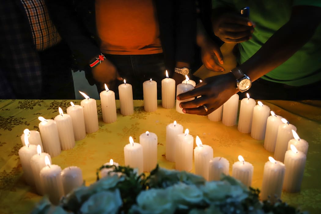 Relatives of victims, who perished among the 157 passengers and crew onboard the Ethiopian Airlines operated Boeing 737 MAX 8 aircraft, light candles during a memorial service at the Kenyan Embassy in Addis Ababa, on March 16, 2019.