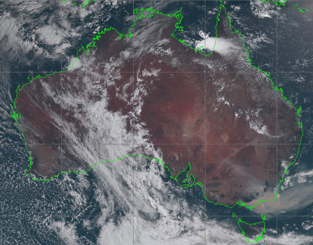 This handout satellite image taken and received on January 3, 2020 from the Japan Meteorological Agency shows an image from the Himawari-8 satellite of Australia, with smoke (bottom R) from bushfires visably drifting off the coast of southeast New South Wales state.