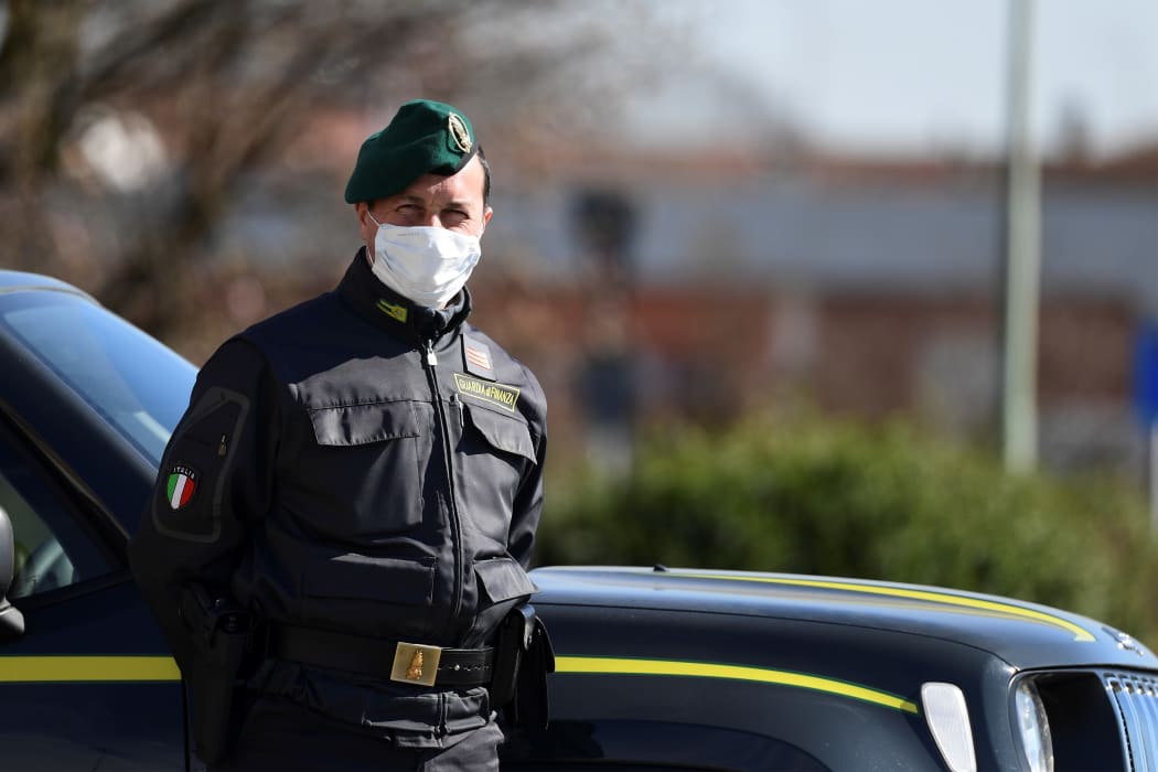 Italian police officer at a checkpoint at the small town of Zorlesco, southeast of Milan, on February 26, 2020.