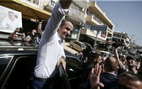 New Democracy leader Kyriakos Mitsotakis sallutes supporters.